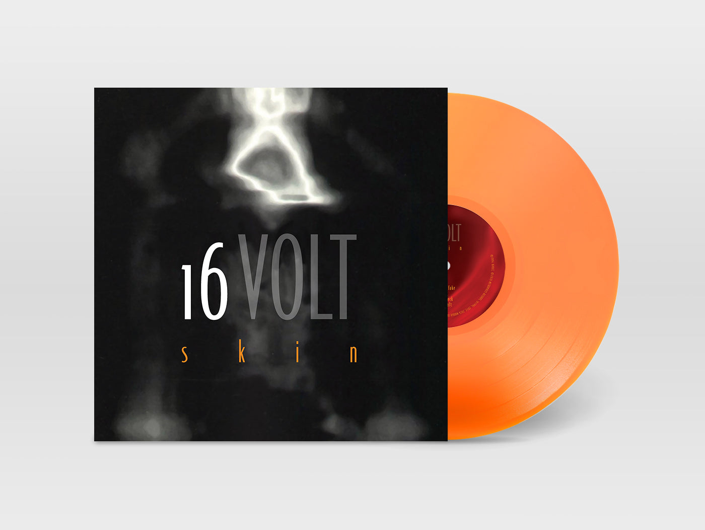 Vinyl record with orange disc and black cover featuring '16 Volt Skin' text on a light gray background
