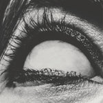Album cover for A Place To Bury Strangers "Pinned" with a close-up of a person's eye with detailed eyelashes and skin texture.