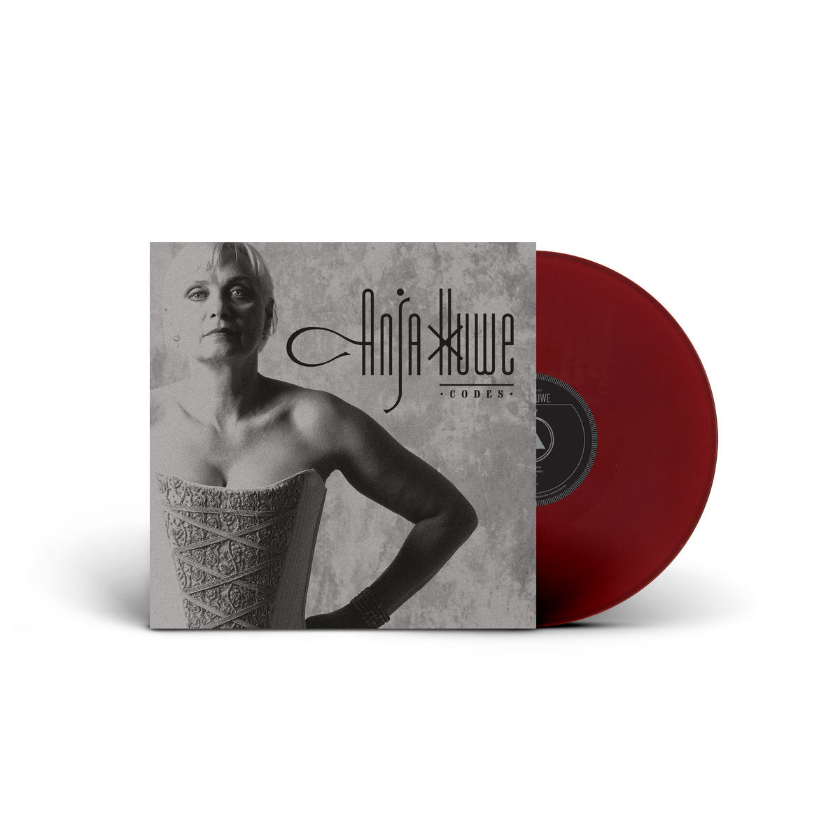 Red vinyl record with a cover featuring a black and white image of a person, on a white background.