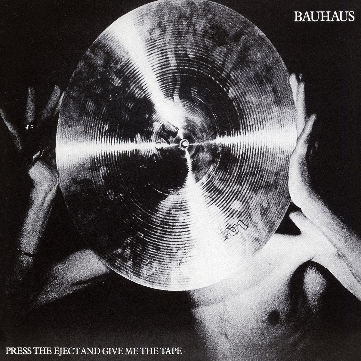 Album cover for Bauhaus - Press The Eject And Give Me The Tape featuring a cymbal held by hands, featuring the text 'BAUHAUS' and 'Press the eject and give me the tape'.