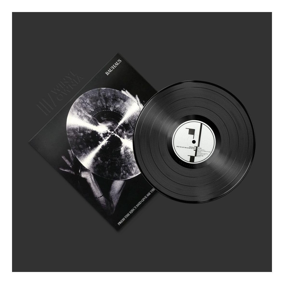 Black vinyl record with a matching cover on a black background