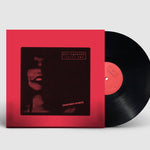Vinyl record with red cover on a light gray background