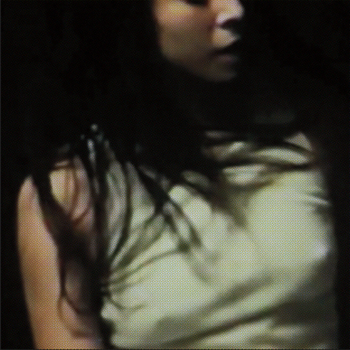 Album cover for 'Yr Body Is Nothing' by Boy Harsher featuring a person with long hair casting a shadow on a light-colored shirt in a dark setting
