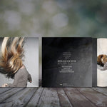 Vinyl record with cover and sleeve on a wooden surface