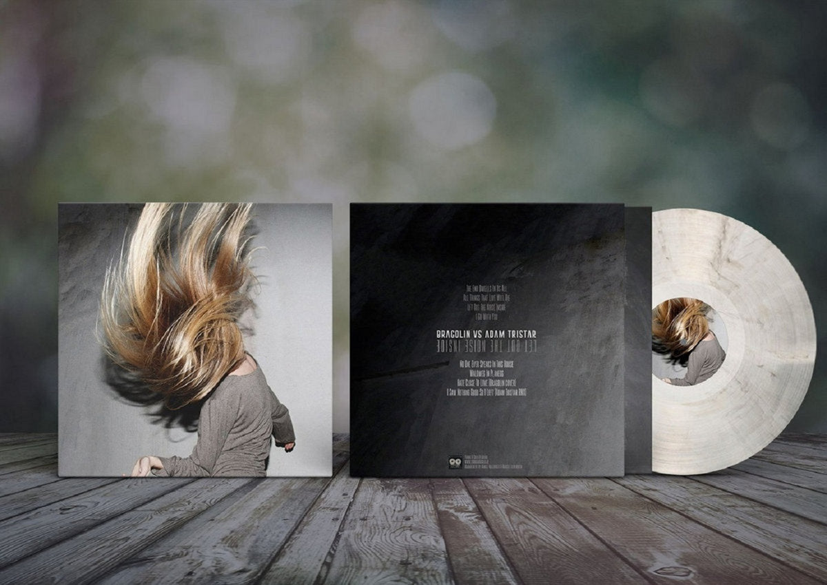 Vinyl record with cover and sleeve on a wooden surface