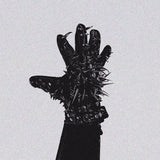 Black glove with spikes on a light gray background