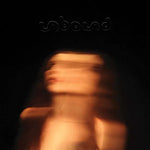 Album cover for 'Unbound' by Chelsea Wolfe featuring a blurred image of her with 'unbound' text above on a dark background