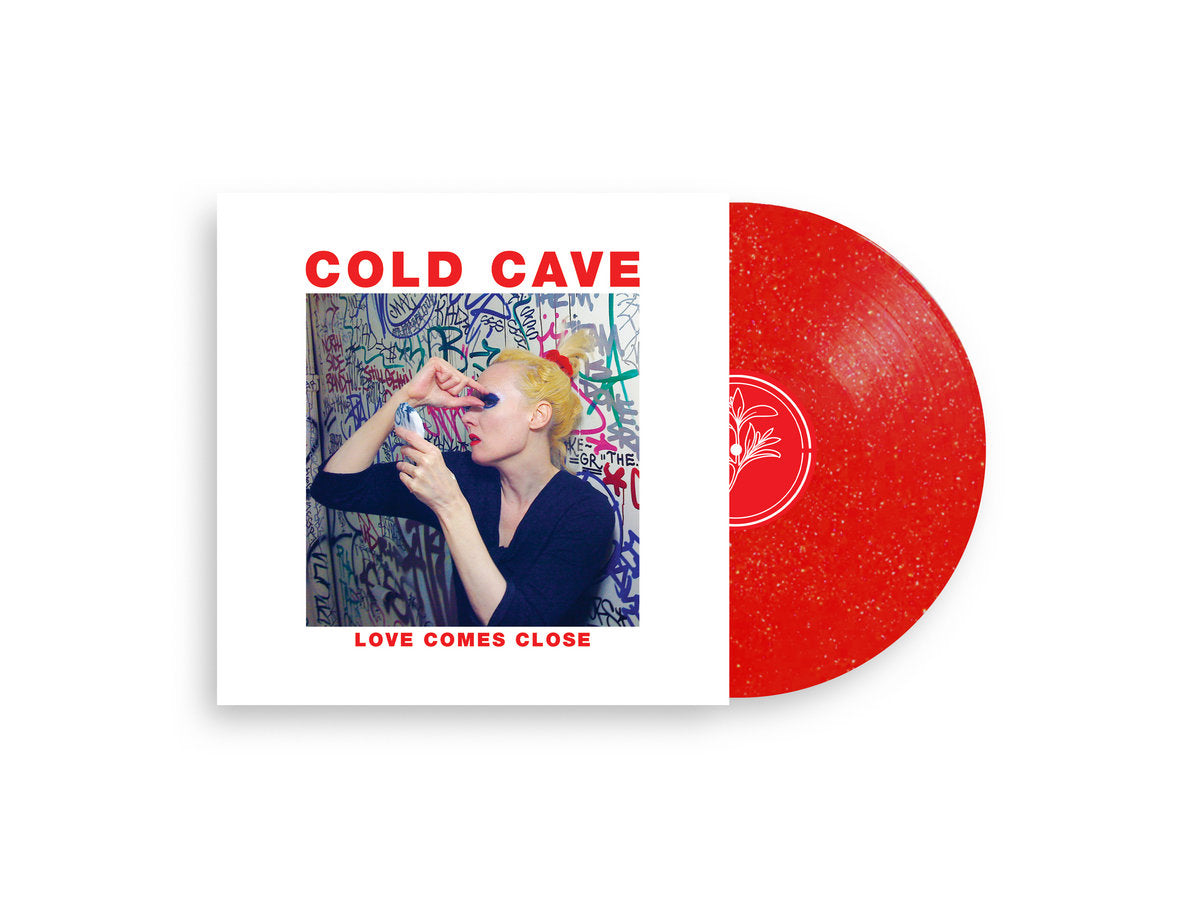 Red vinyl record with a person on the cover titled 'Cold Cave Love Comes Close'.
