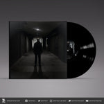 Vinyl record with a dark cover featuring a silhouette of a person in a hallway.