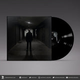 Vinyl record with a dark cover featuring a silhouette of a person in a hallway.