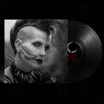Vinyl record with a stylized face design on a black background