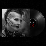 Vinyl record with a stylized face design on a black background