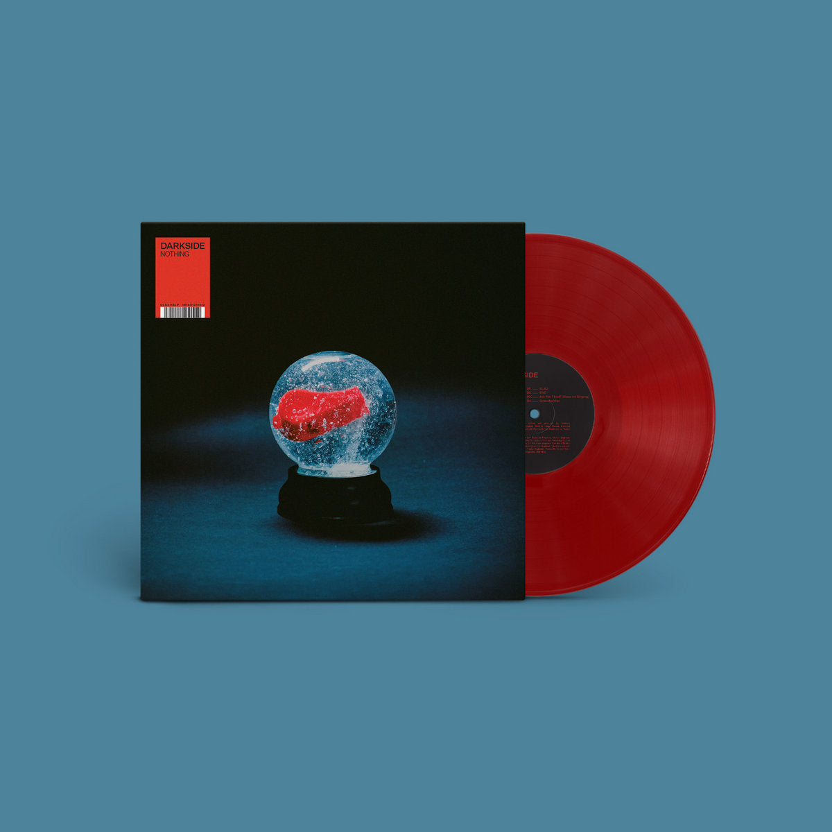 Vinyl record with a red and blue globe design on the cover against a blue background