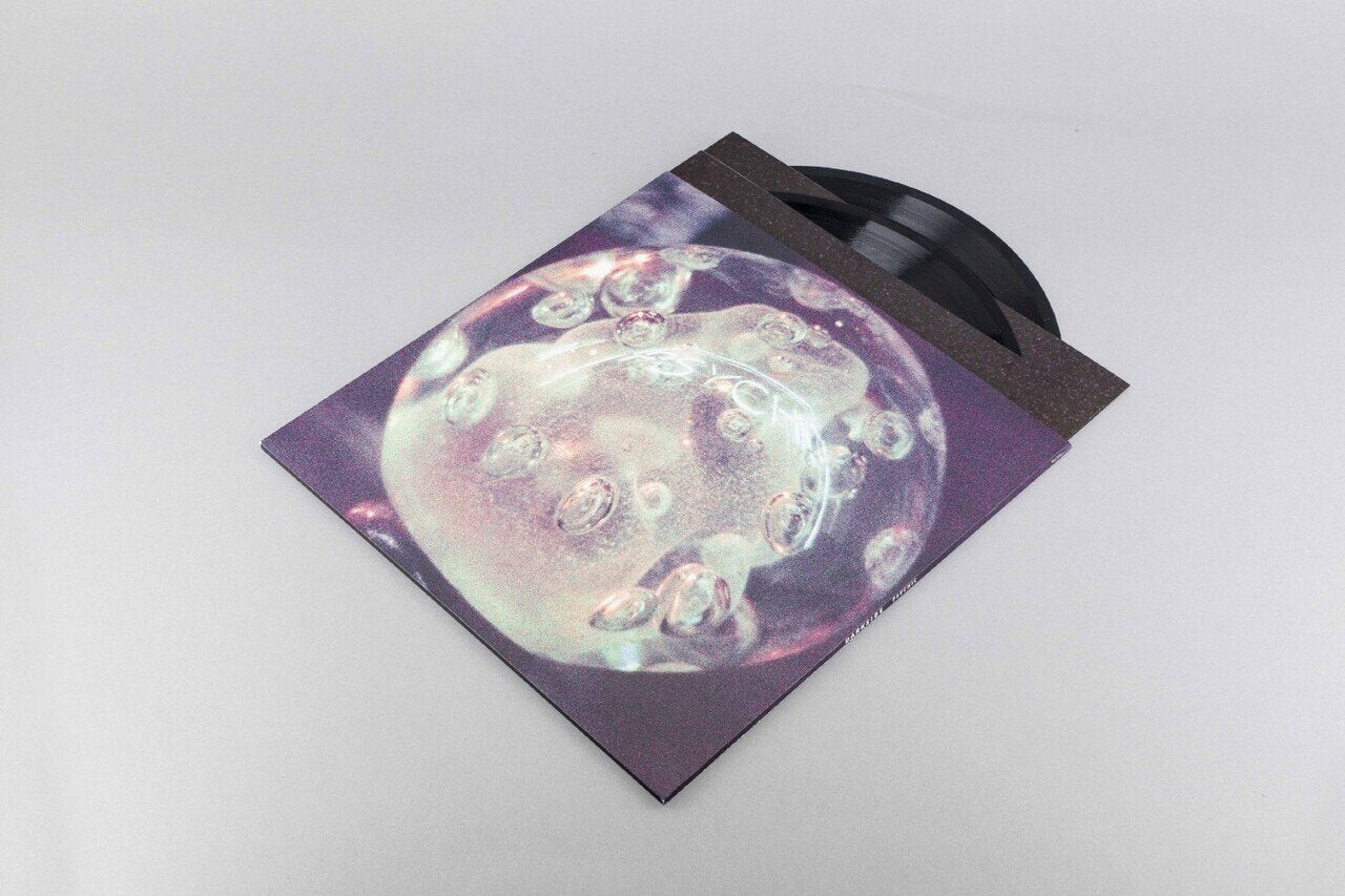 Vinyl record with a cover featuring a bubble-like design on a light gray background