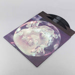 Vinyl record with a cover featuring a bubble-like design on a light gray background