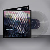 Vinyl record with cover and clear disc on a gray background