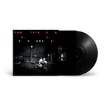 Vinyl record with a black and white cover featuring text and images on a white background