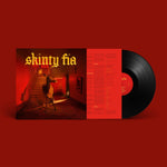 Vinyl record with 'shiny fia' album cover on a red background