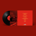 Vinyl record with red cover featuring album tracklist on a red background