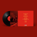 Vinyl record with red cover featuring album tracklist on a red background