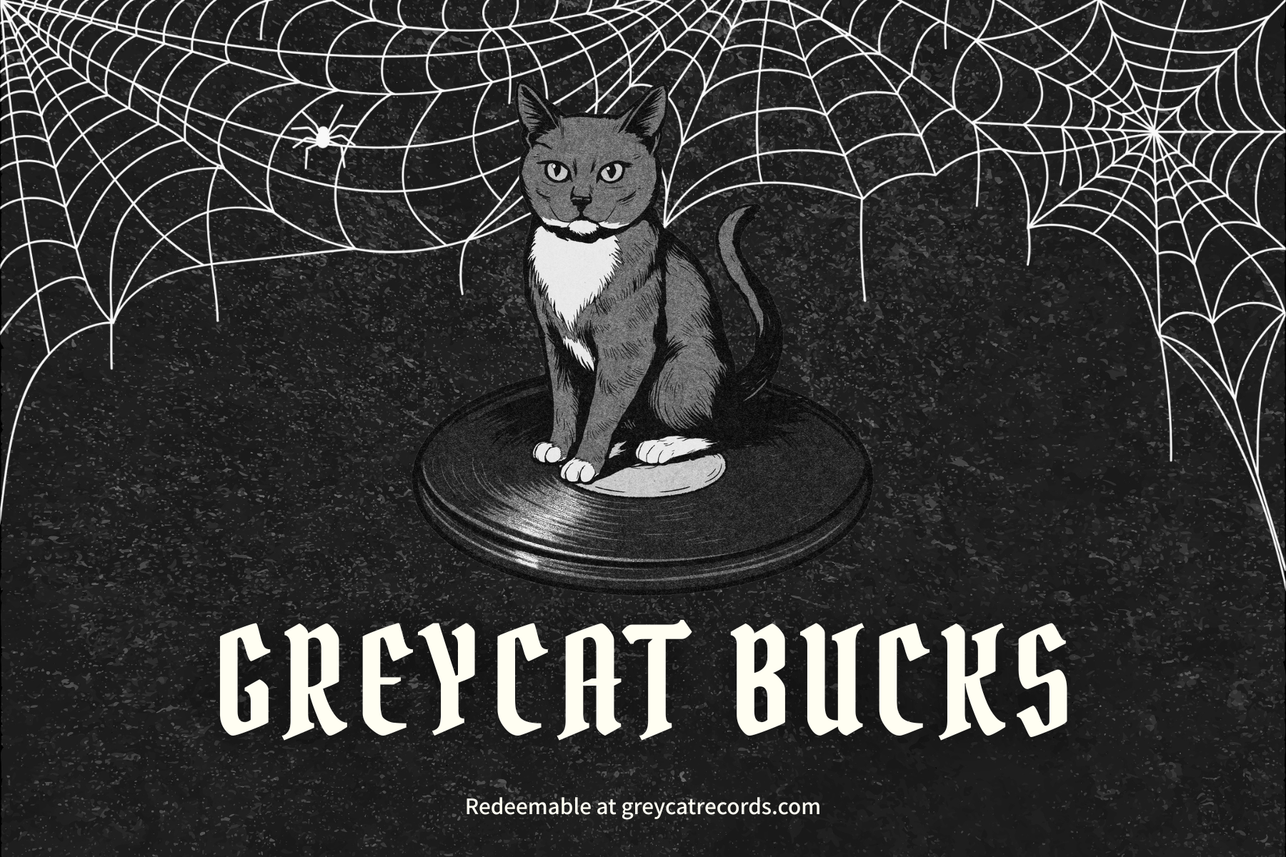 Cat figurine on a record with spider web design and 'Greycat Bucks' text.