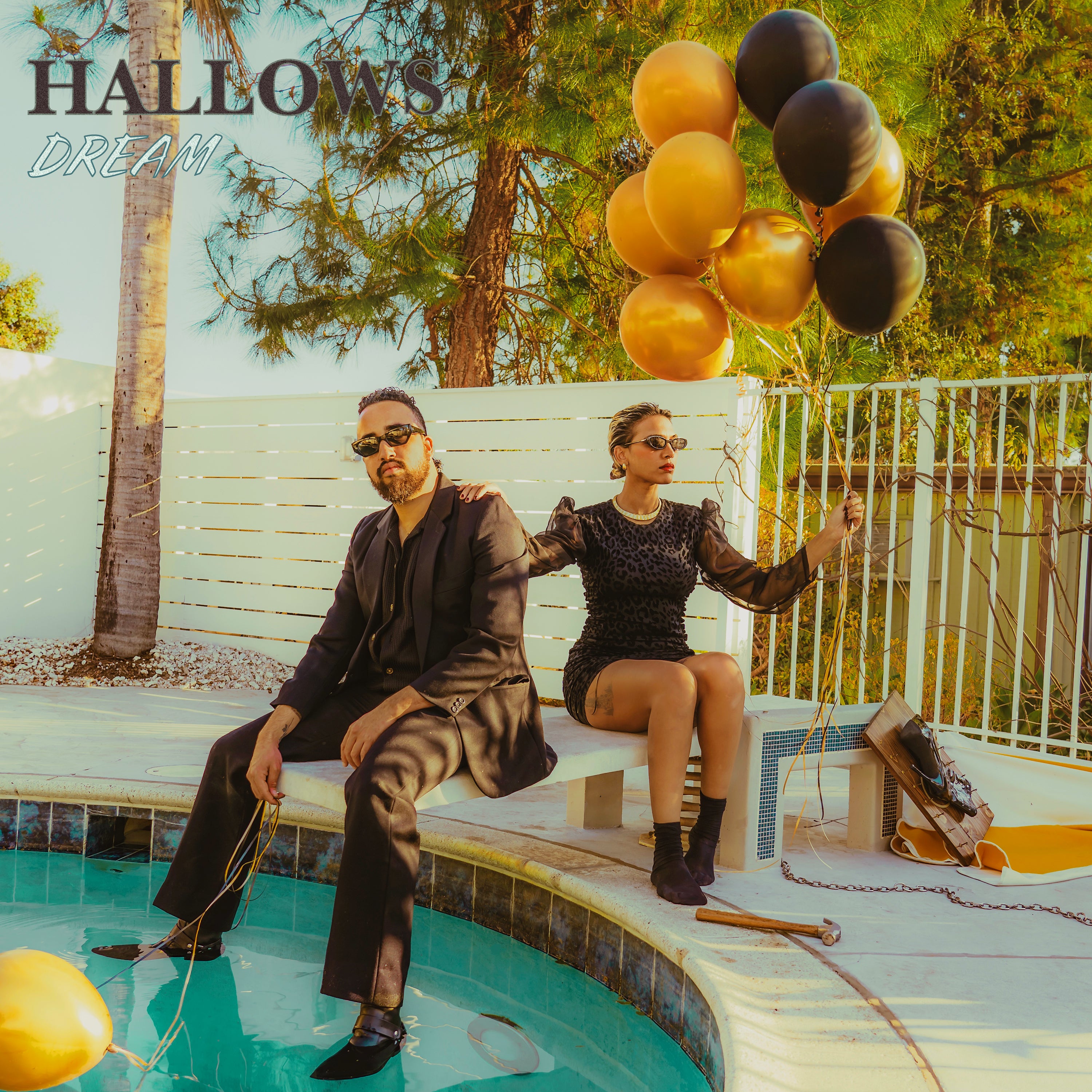 Two people sitting by a pool with balloons, with 'Hallows Dream' text at the top.