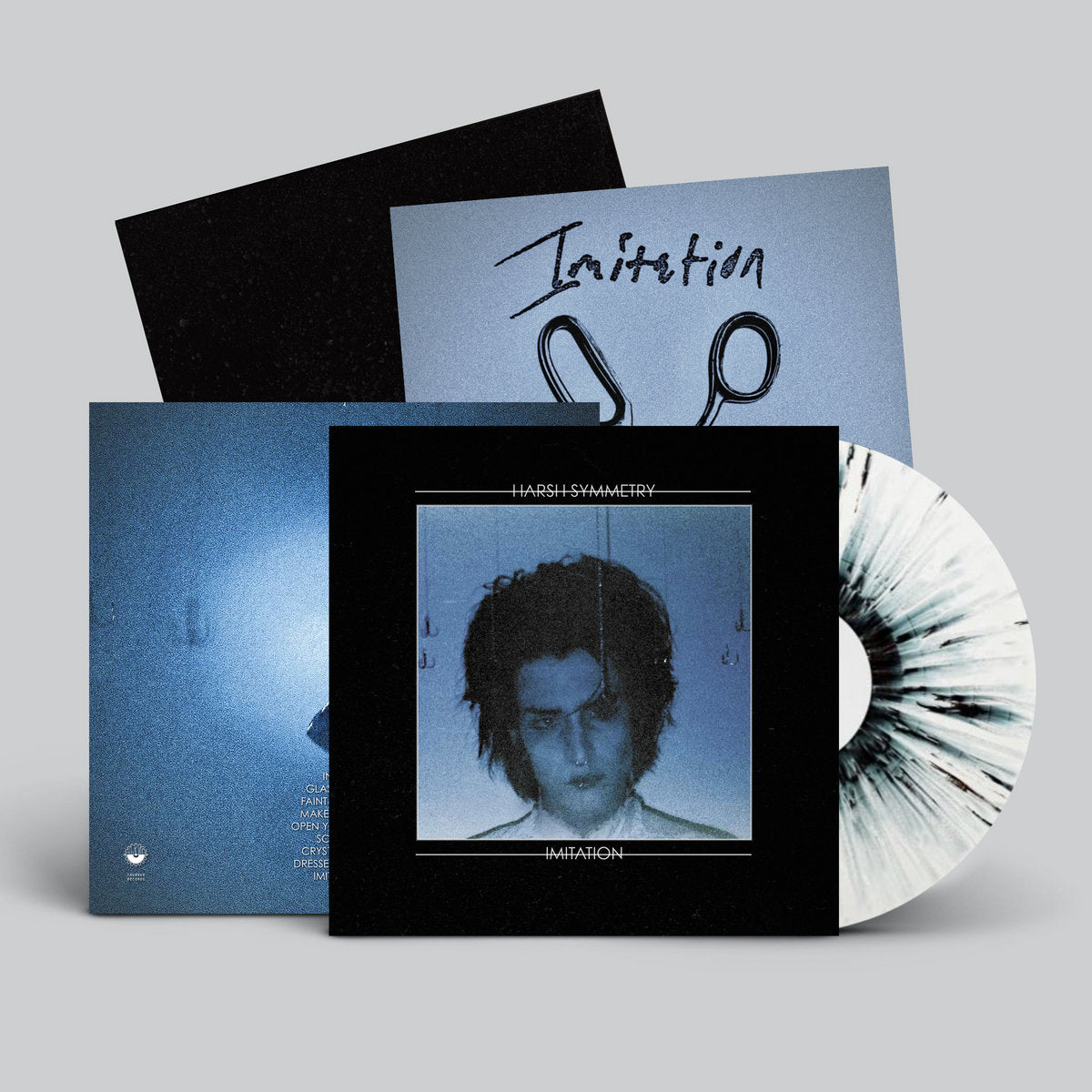 Vinyl record with cover and additional materials on a gray background