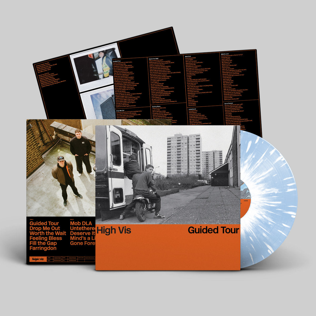 Vinyl record with cover and splatter design on a gray background