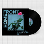 Vinyl record with a cover featuring a plant and pink flower on a white background with black dots.