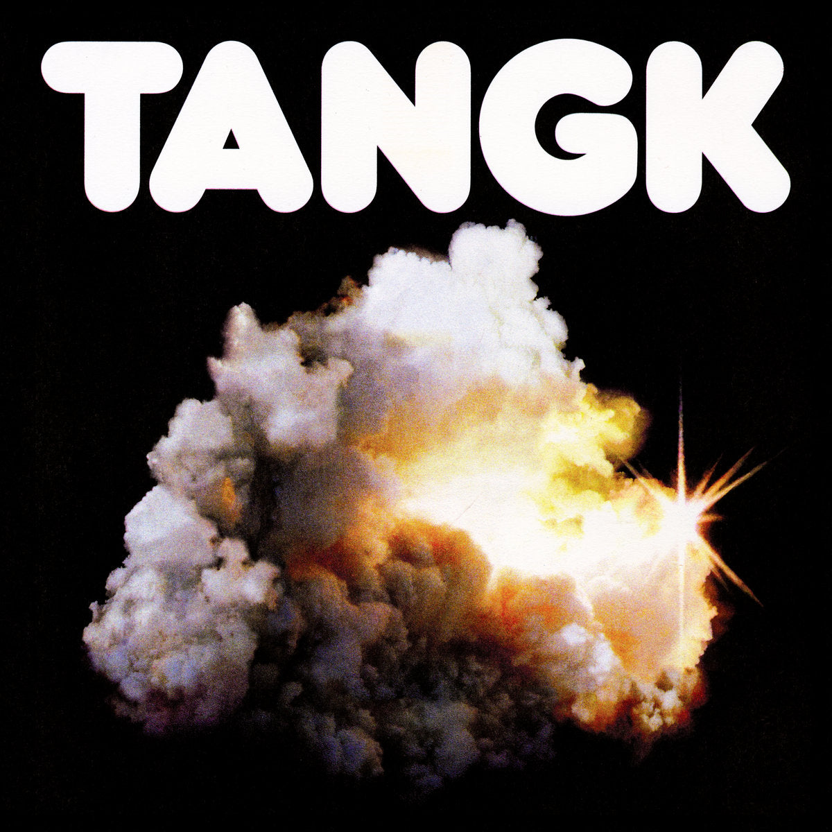Album cover for 'Tangk' by IDLES featuring an explosion with smoke and bright light on a black background, featuring the word 'TANGK'.