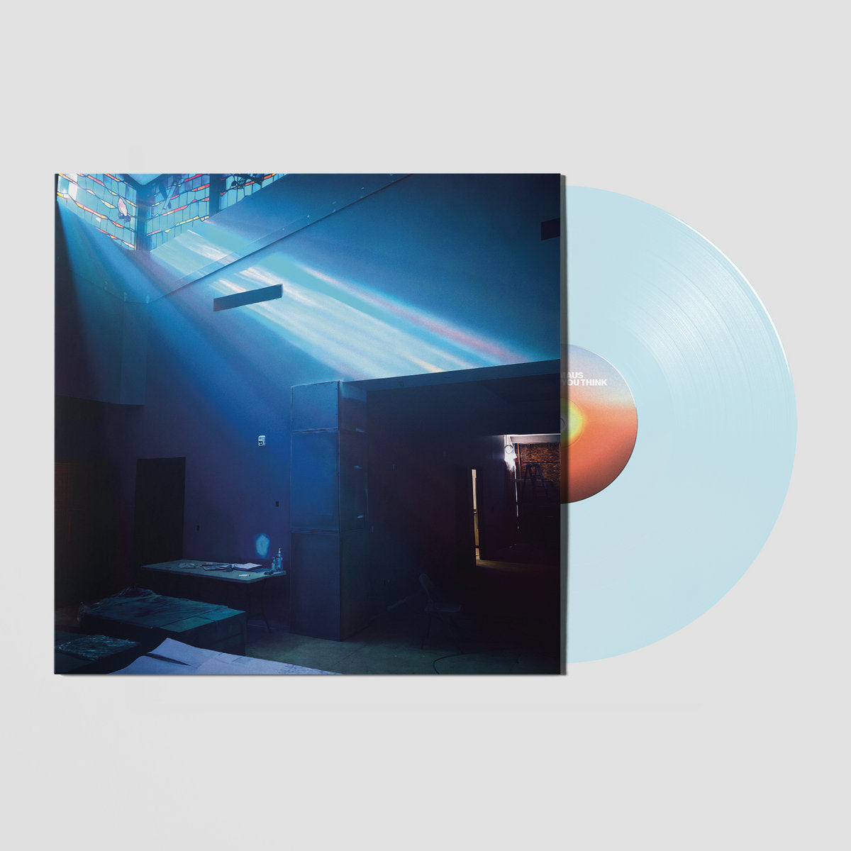 Vinyl record with a cover featuring a blue interior scene and a gradient color vinyl.