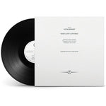 Vinyl record with white cover featuring text on a white background