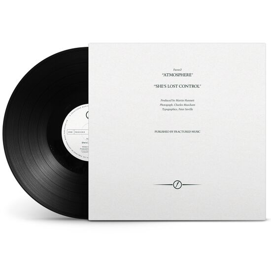 Vinyl record with white cover featuring text on a white background