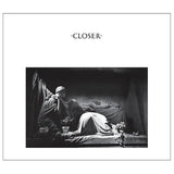 Album cover for 'Closer' by Joy Division with a black and white scene of a person lying down.