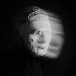 Album cover for Kontravoid's 'Detachment' featuring a person wearing a mask with a blurred background