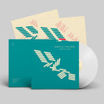 Vinyl record with teal cover and white disc on a gray background