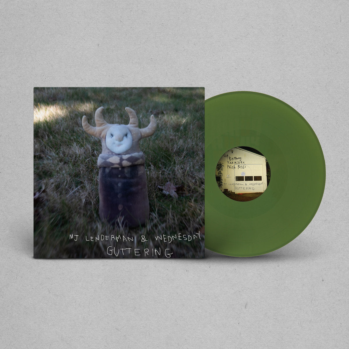 Green vinyl record with a cover featuring a creature in a field on a gray background