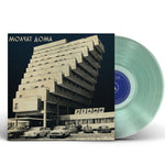 Vinyl record with a cover featuring a building and text on a white background