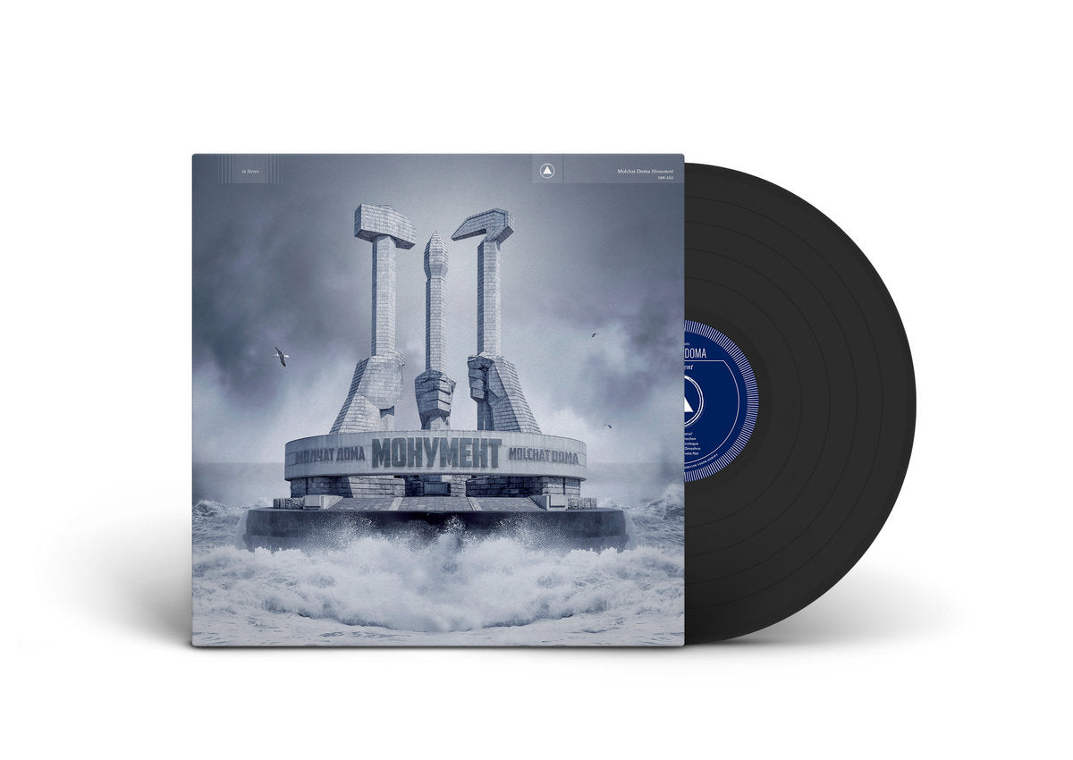 Vinyl record with a cover featuring a futuristic structure and the word 'Momentum'.