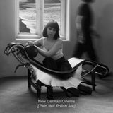 Black and white photo of a woman sitting on a modernist chair with a blurred figure in the background.