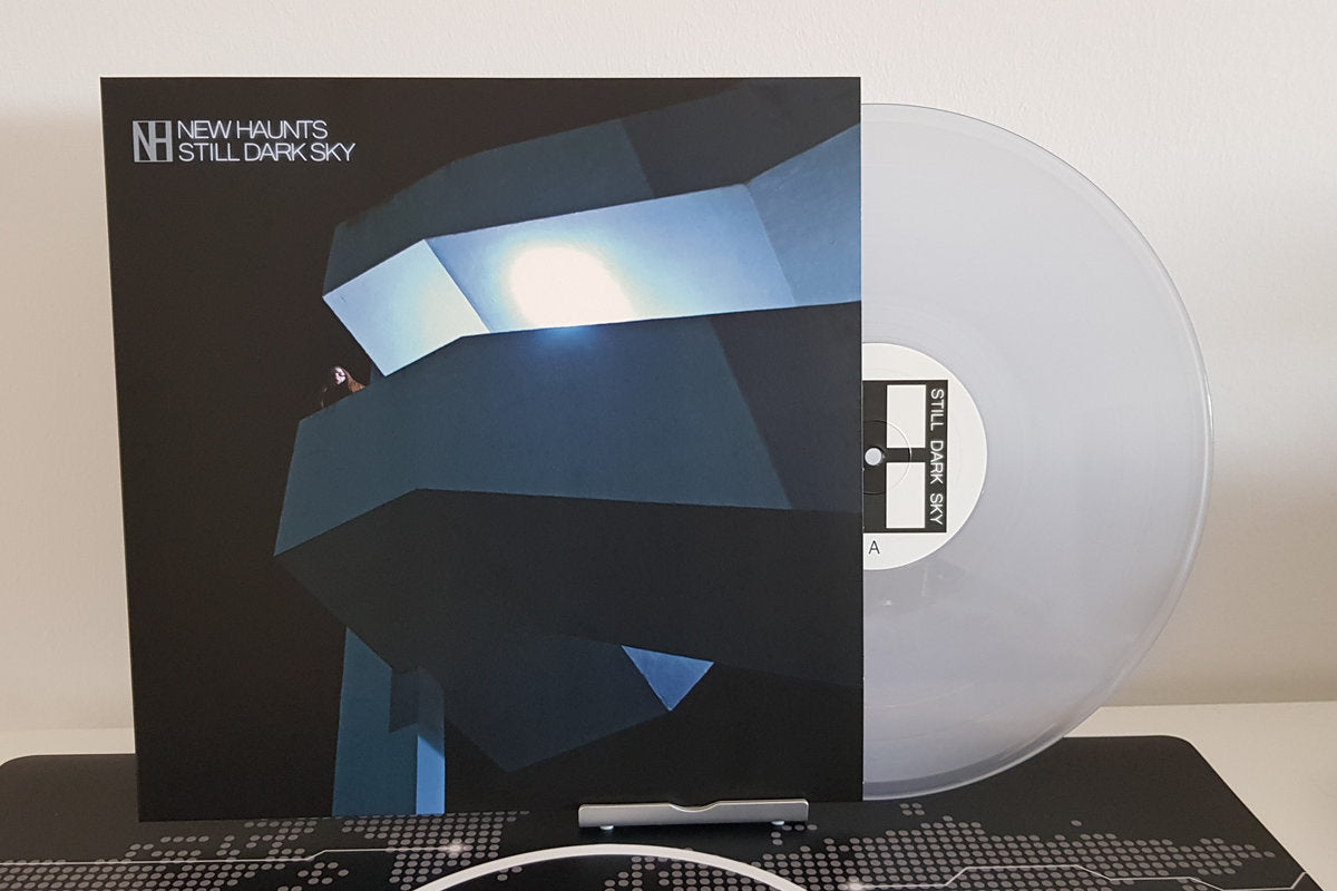 Vinyl record with cover titled 'Still Dark Sky' by New Haunts with a white wall background