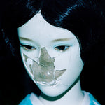 Album cover for NewDad's 'Madra' featuring a mannequin face with dark hair against a black background