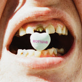 Mouth with a candy heart labeled 'NOTHING' inside