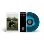 Vinyl record with blue disc and cover featuring a person in a field, labeled 'Formless'.