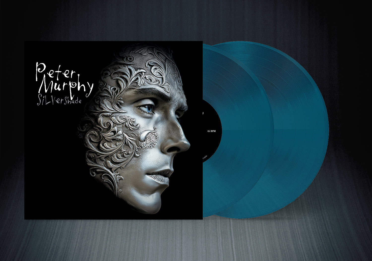Vinyl record with a stylized face design on the cover and blue vinyl disc.