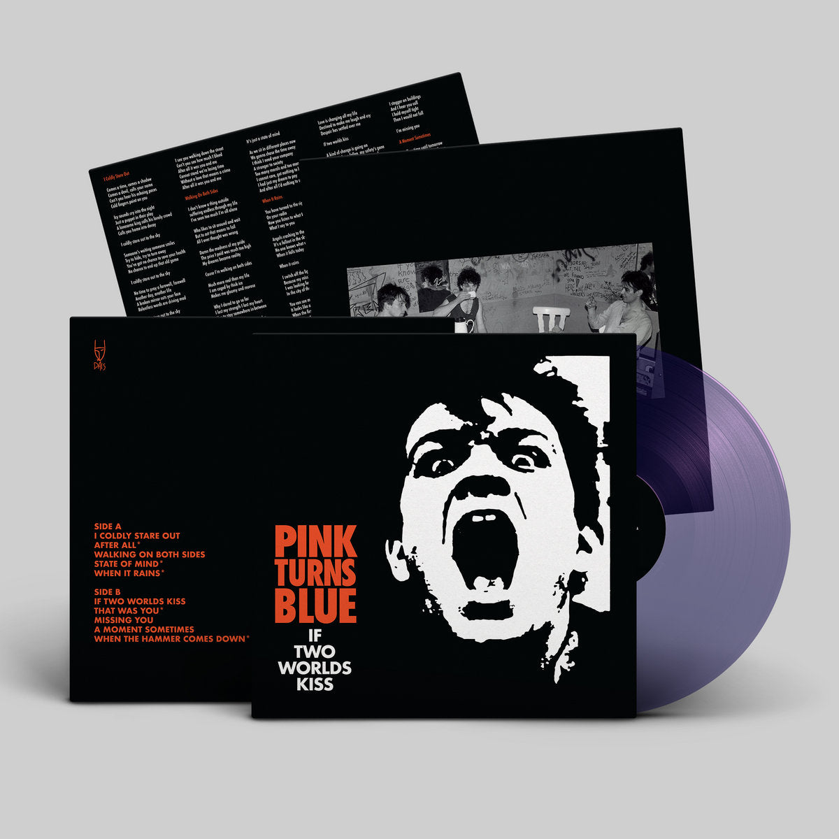 Vinyl record with black cover featuring a white graphic and red text on a gray background