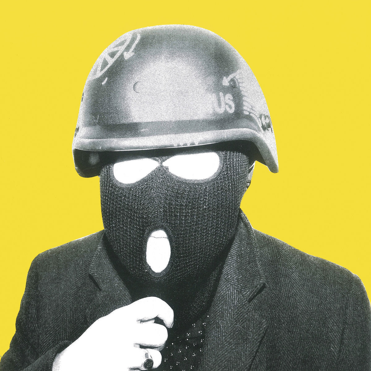 Person wearing a helmet and balaclava with a yellow background