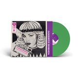 Green vinyl record with a stylized cover featuring a woman's face and text, on a white background.
