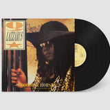 Vinyl record with a cover featuring a person in a hat and sunglasses, with 'Q Lazzarus' text.