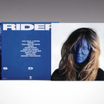 Vinyl record with blue cover and white text, featuring a person's face and album title 'Rider'.